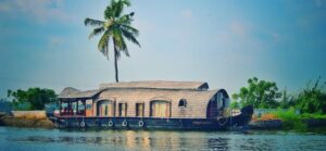 Picturesque view of river with green palms on bank and shabby wooden boathouse under blue sky in tropical countryside